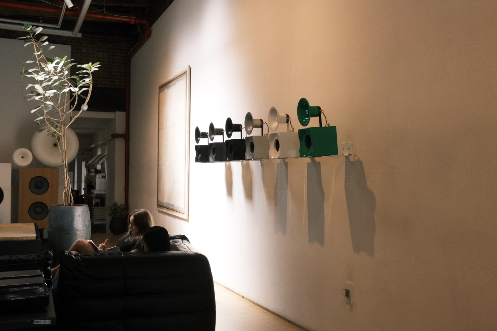 Gallery wall with a row of horn speakers, shot on X100V