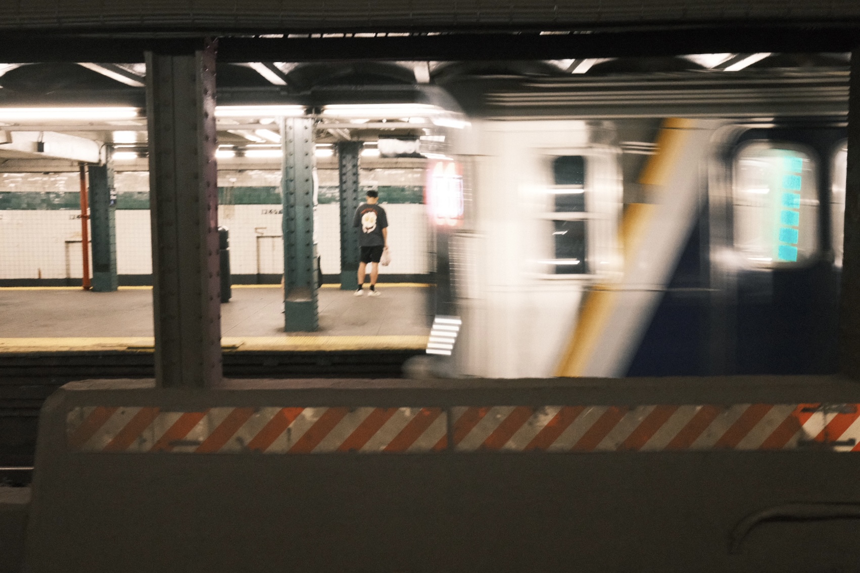 NYC subway platform with a train in motion, shot on X100V